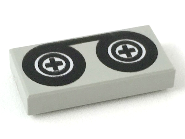 Part 3069p02 - Tile 1 x 2 with Black Tape Reels Pattern - De BrickPlaats